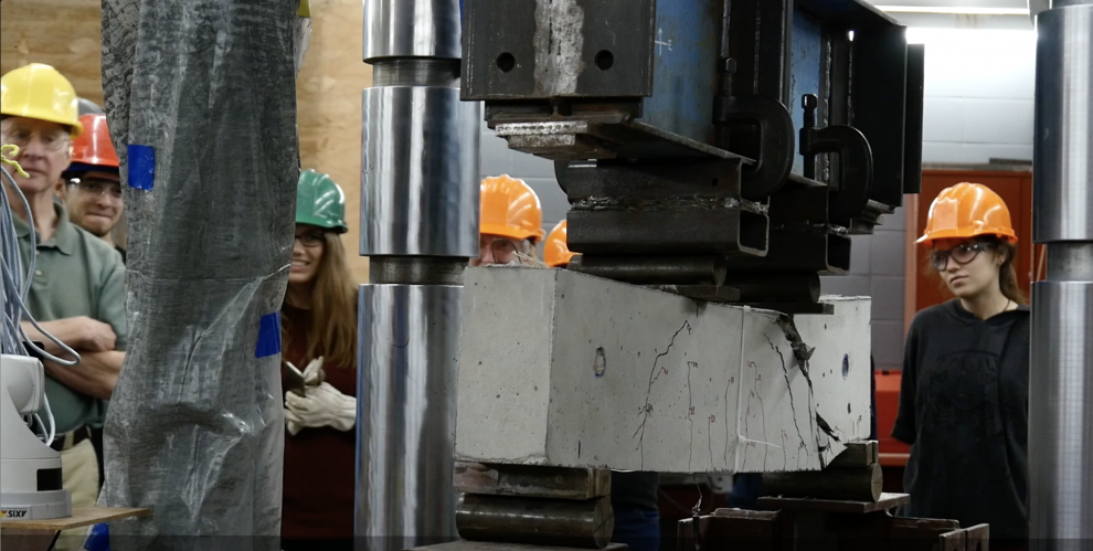 students testing concrete beam